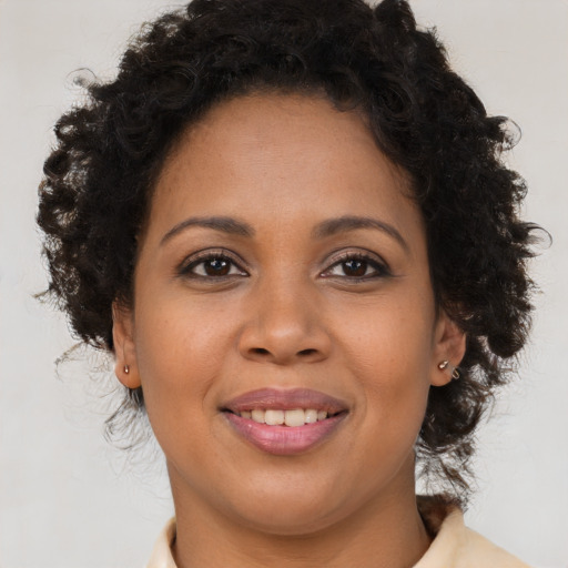 Joyful black young-adult female with medium  brown hair and brown eyes