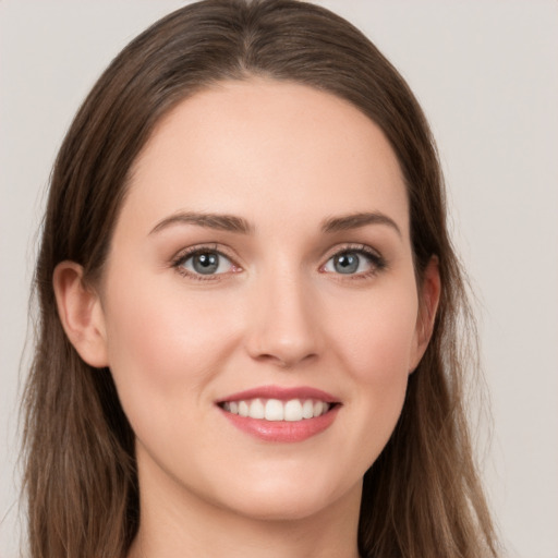 Joyful white young-adult female with long  brown hair and grey eyes