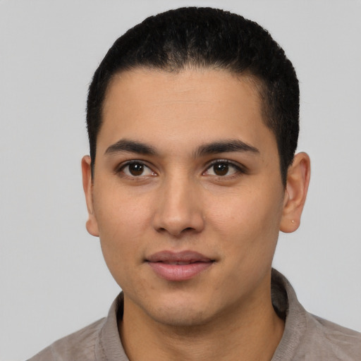 Joyful latino young-adult male with short  black hair and brown eyes