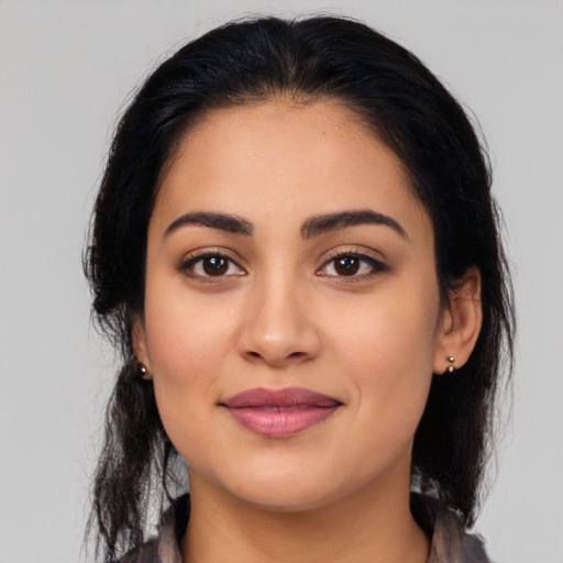 Joyful latino young-adult female with medium  black hair and brown eyes