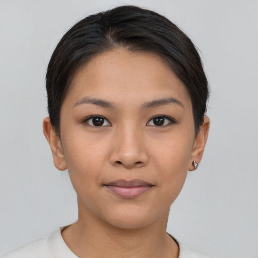 Joyful latino young-adult female with short  brown hair and brown eyes