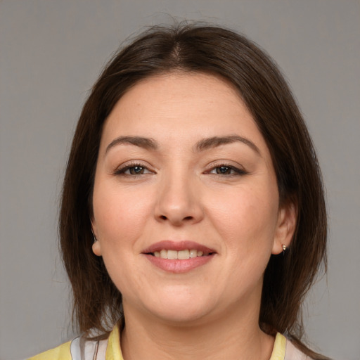 Joyful white young-adult female with medium  brown hair and brown eyes