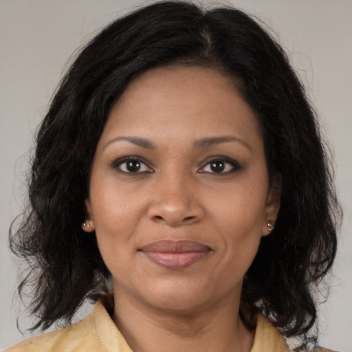 Joyful black adult female with medium  brown hair and brown eyes