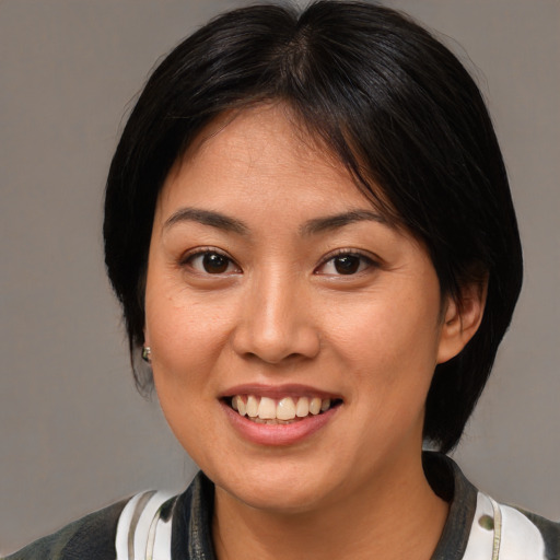 Joyful asian young-adult female with medium  brown hair and brown eyes