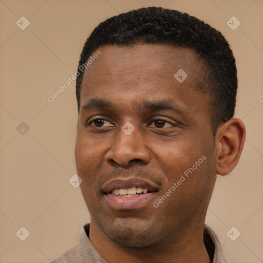 Joyful black young-adult male with short  black hair and brown eyes