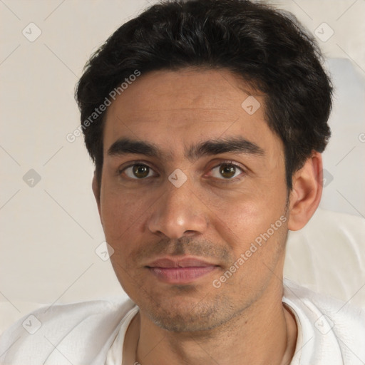 Joyful white young-adult male with short  black hair and brown eyes