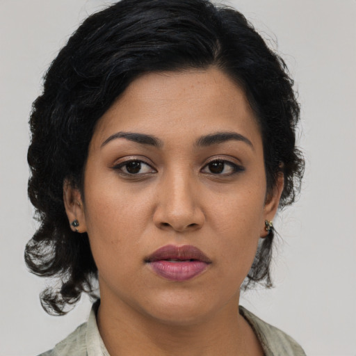 Joyful latino young-adult female with medium  black hair and brown eyes