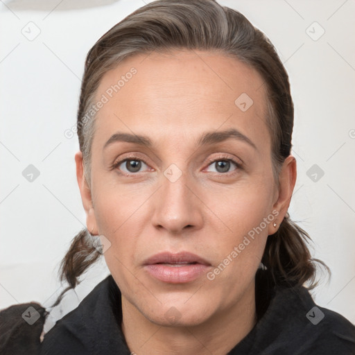 Joyful white adult female with medium  brown hair and grey eyes