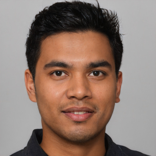 Joyful latino young-adult male with short  brown hair and brown eyes