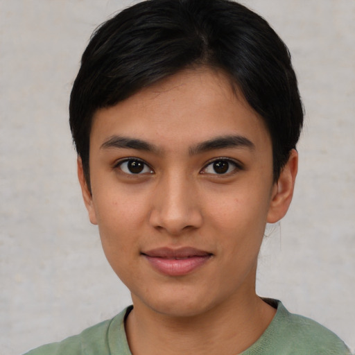 Joyful asian young-adult female with short  black hair and brown eyes