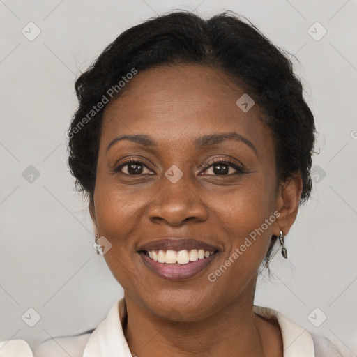 Joyful black adult female with short  brown hair and brown eyes