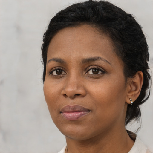 Joyful black young-adult female with medium  brown hair and brown eyes