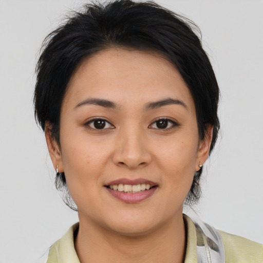 Joyful asian young-adult female with medium  brown hair and brown eyes