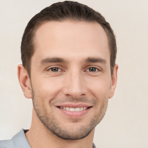 Joyful white young-adult male with short  brown hair and brown eyes