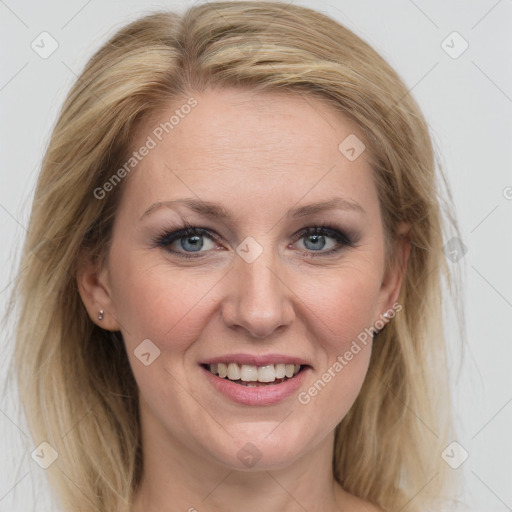 Joyful white adult female with medium  brown hair and blue eyes