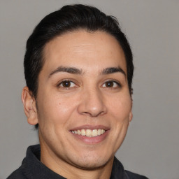 Joyful white adult male with short  brown hair and brown eyes