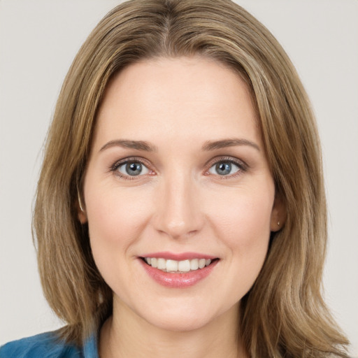 Joyful white young-adult female with medium  brown hair and blue eyes