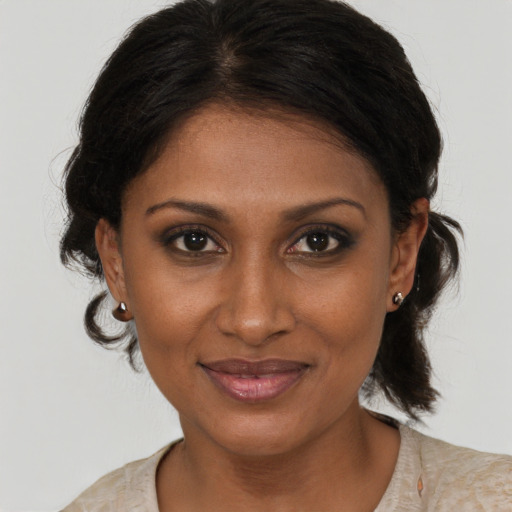 Joyful black young-adult female with medium  brown hair and brown eyes