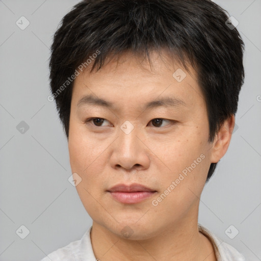 Joyful asian young-adult male with short  brown hair and brown eyes