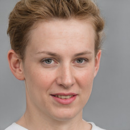 Joyful white young-adult female with short  brown hair and blue eyes