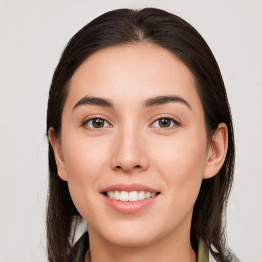 Joyful white young-adult female with long  brown hair and brown eyes