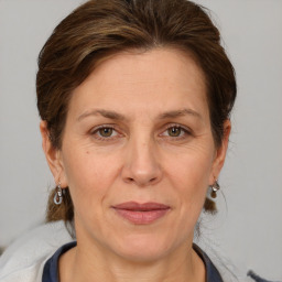 Joyful white adult female with medium  brown hair and grey eyes