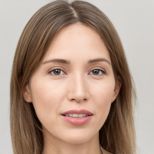 Joyful white young-adult female with long  brown hair and grey eyes