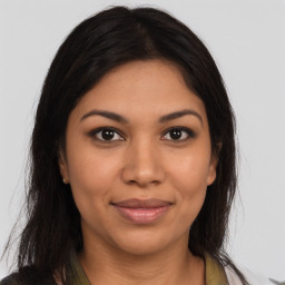 Joyful latino young-adult female with long  brown hair and brown eyes