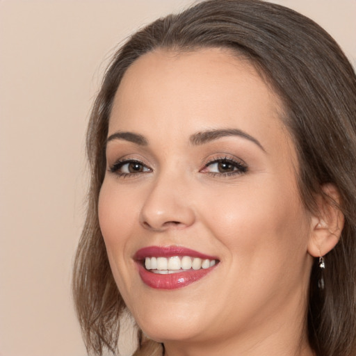 Joyful white young-adult female with medium  brown hair and brown eyes