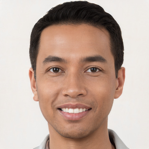 Joyful white young-adult male with short  black hair and brown eyes