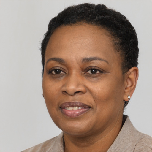 Joyful black adult female with short  black hair and brown eyes