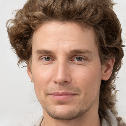 Joyful white young-adult male with medium  brown hair and brown eyes