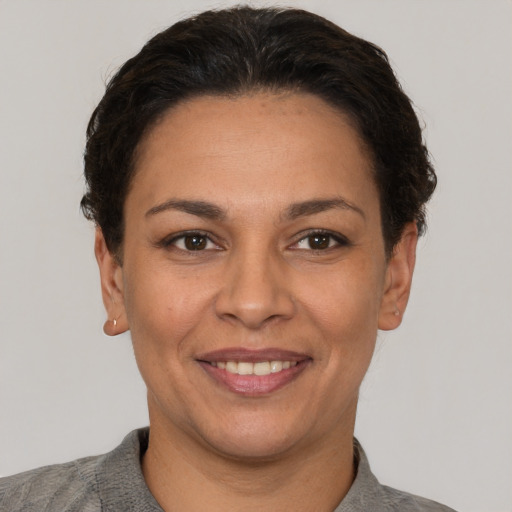 Joyful white adult female with short  brown hair and brown eyes