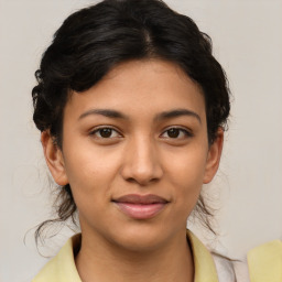 Joyful latino young-adult female with medium  brown hair and brown eyes