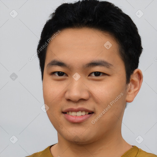 Joyful asian young-adult male with short  black hair and brown eyes