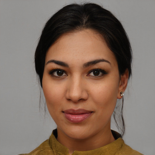 Joyful latino young-adult female with medium  brown hair and brown eyes