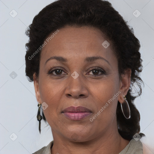 Joyful black adult female with medium  brown hair and brown eyes