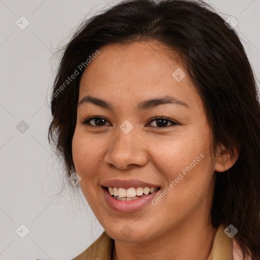 Joyful latino young-adult female with long  brown hair and brown eyes