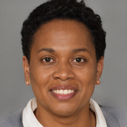 Joyful black young-adult female with short  brown hair and brown eyes
