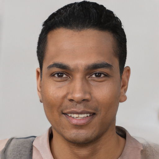 Joyful latino young-adult male with short  black hair and brown eyes