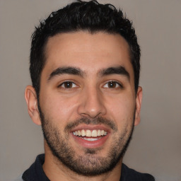 Joyful latino young-adult male with short  black hair and brown eyes