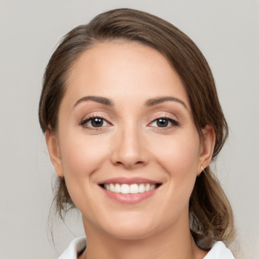 Joyful white young-adult female with medium  brown hair and brown eyes