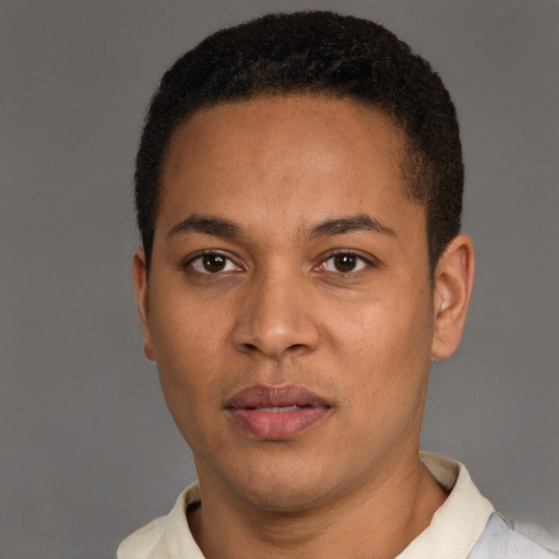 Joyful latino young-adult male with short  brown hair and brown eyes