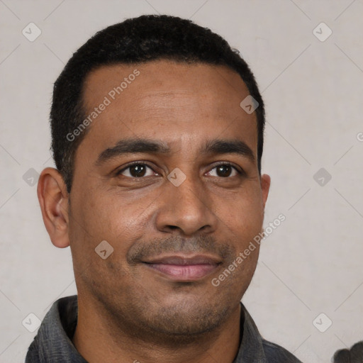 Joyful latino young-adult male with short  brown hair and brown eyes