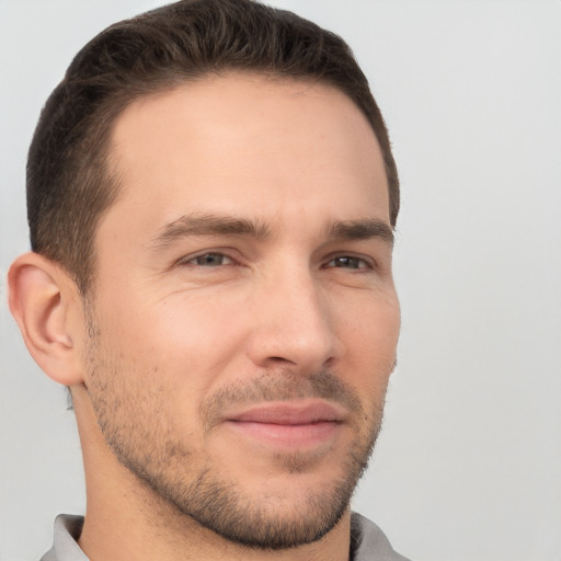 Joyful white young-adult male with short  brown hair and brown eyes