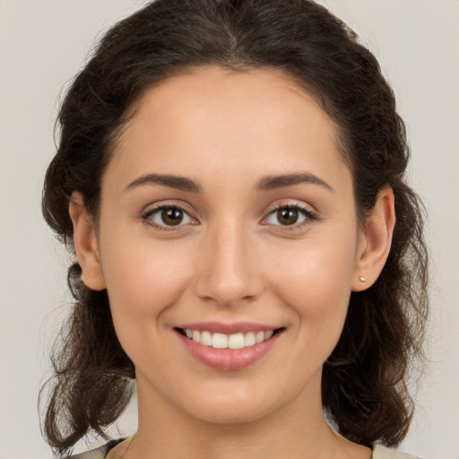 Joyful white young-adult female with medium  brown hair and brown eyes