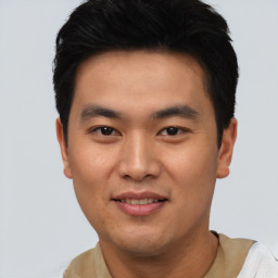 Joyful asian young-adult male with short  black hair and brown eyes