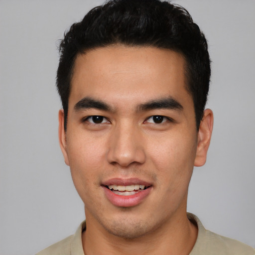 Joyful latino young-adult male with short  brown hair and brown eyes
