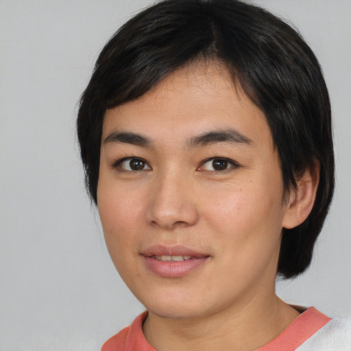 Joyful asian young-adult female with short  brown hair and brown eyes