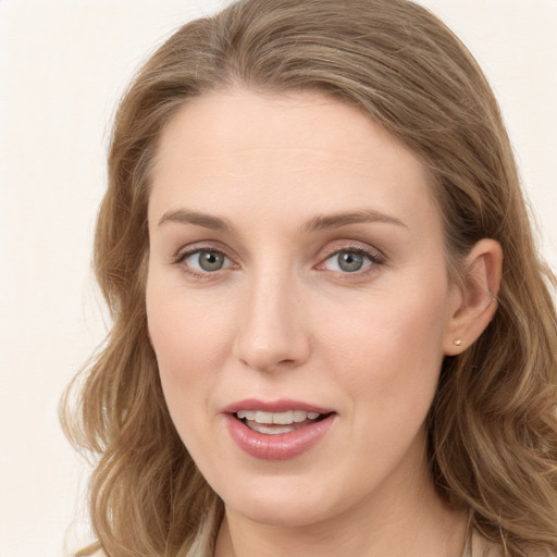 Joyful white young-adult female with long  brown hair and blue eyes